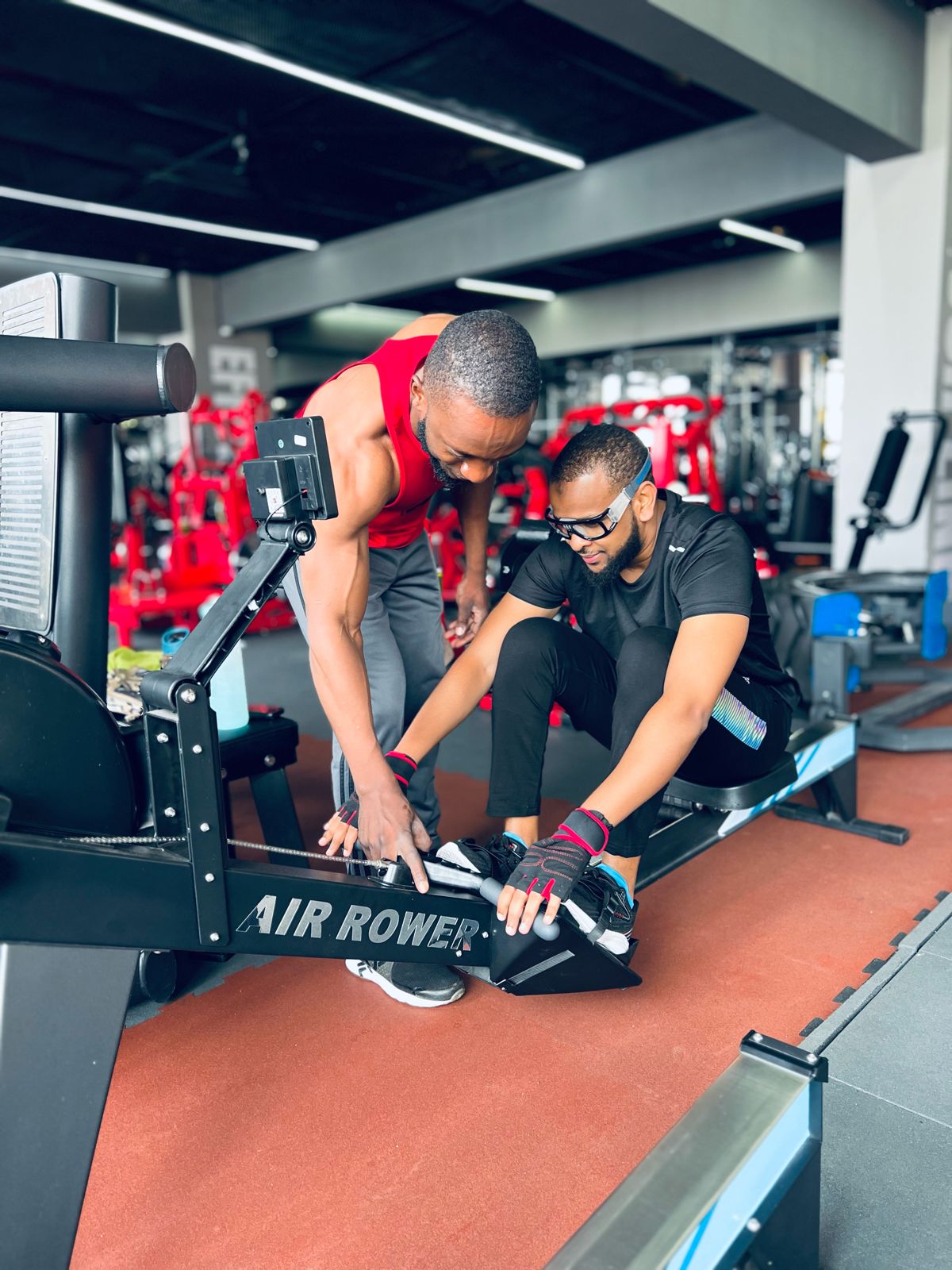 Coach guiding a member on the rower